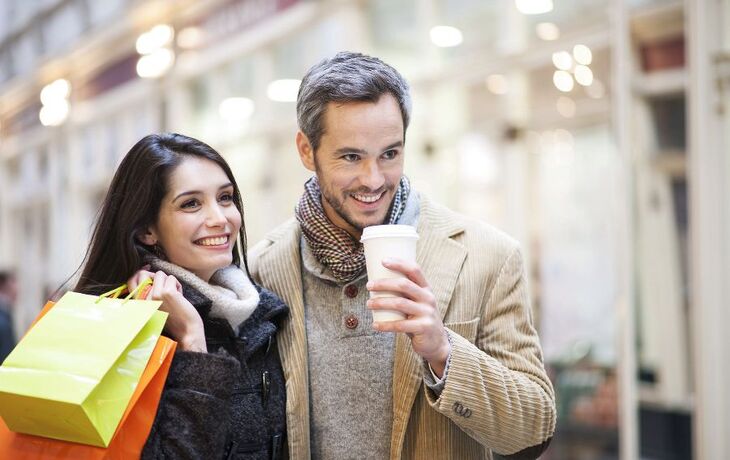 handsome couple doing shopping city lights in the background